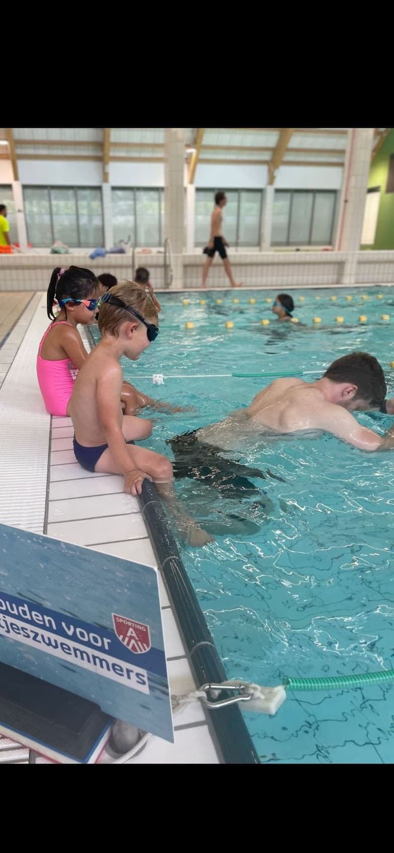 Happy child learning to swim